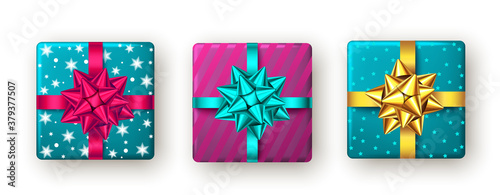 Pink, golden, blue gift box with ribbon and bow, top view.