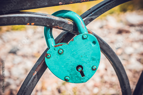 A padlock that is traditionally hung by the newlyweds on the railing of the bridge after the wedding photo