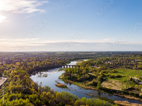 Areal countryside view from drone with small river Venta.