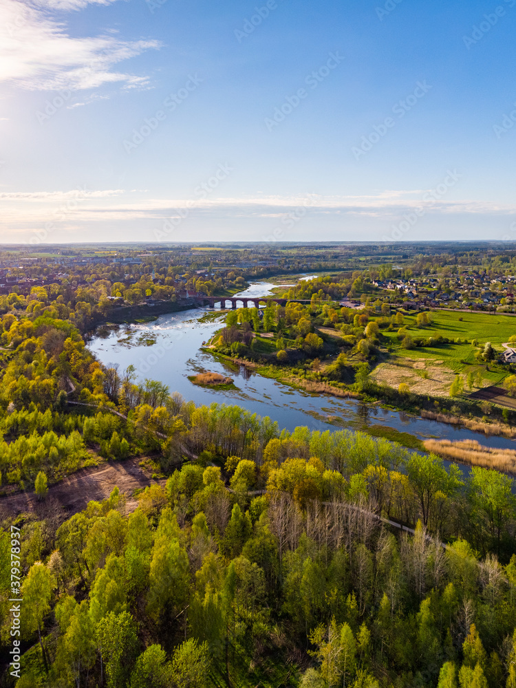Areal countryside view from drone with small river Venta.