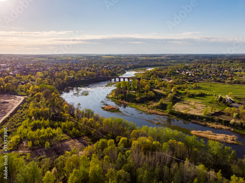 Areal countryside view from drone with small river Venta.