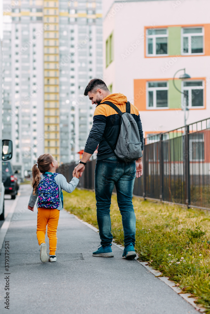 Father and daughter going to school for the first time. Back to school after pandemic.