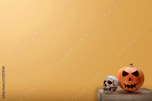 Jack-o-Lantern and human skull on the table