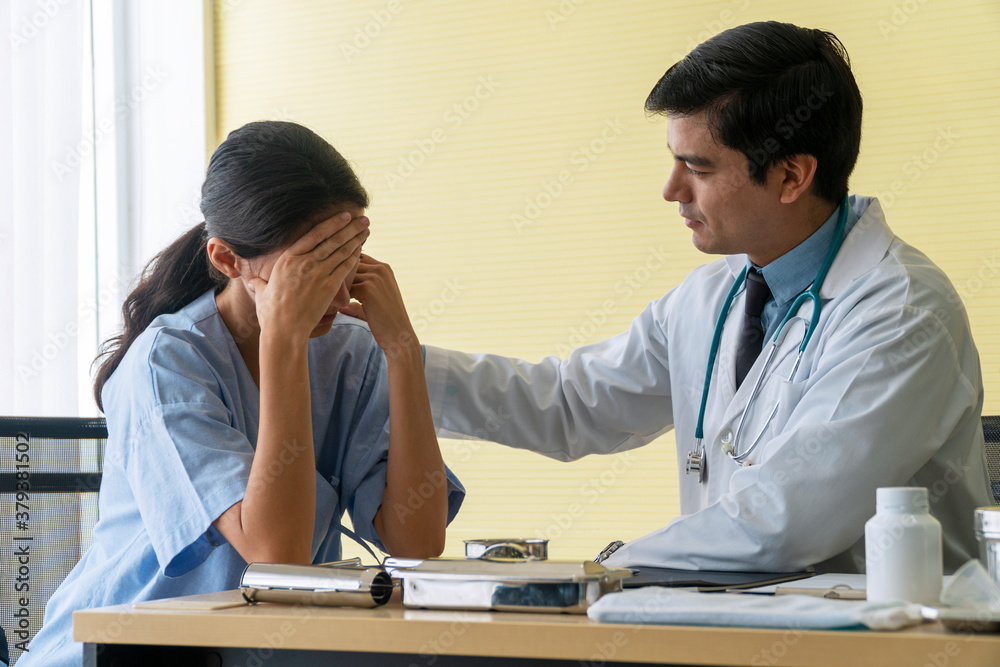 Doctor man wear uniform with pen and stethoscope sitting in office while talking about problem health patient woman fell friendly. Patient young woman listen advice doctor. Health-care concept. Doctor man wear uniform with pen and stethoscope sitting in office while talking about problem health patient woman fell friendly. Patient young woman listen advice doctor. Health-care concept.