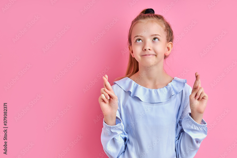 luck concept. adorable caucasian girl wants her dreams to come true, holds fingers together luck concept. adorable caucasian girl wants her dreams to come true, holds fingers together