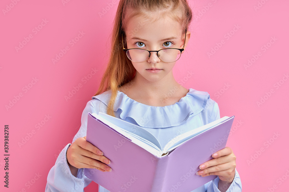 adorable caucasian girl in eyeglasses read a book isolated, smart intelligent child love learning, studying, keen on education adorable caucasian girl in eyeglasses read a book isolated, smart intelligent child love learning, studying, keen on education