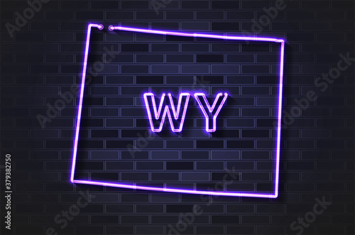 Wyoming map glowing neon lamp or glass tube on a black brick wall