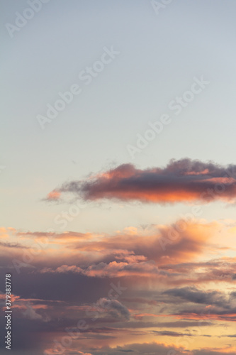 Evening sky with rain clouds in orange-pink sunset light © Регина Шарипова