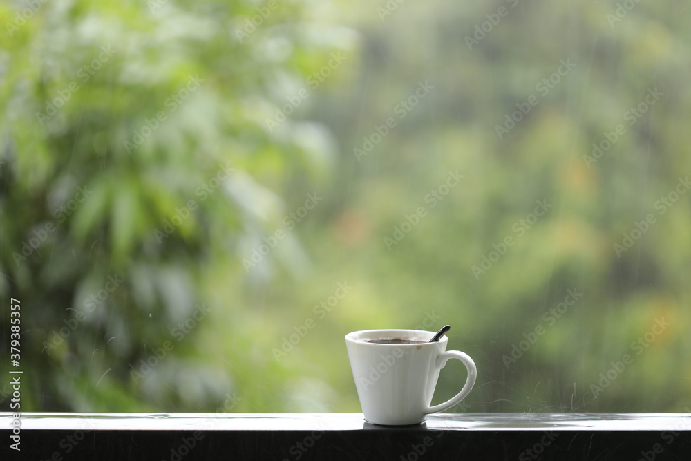 White coffee on balcony railing frame on rainy day White coffee on balcony railing frame on rainy day