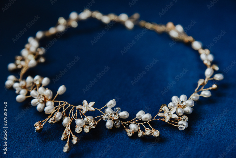 pearl necklace on blue background. 
pearl crown for wedding hairstyle