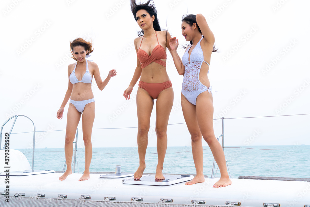 sexy beautiful group asian model young lady in bikini dancing on boat yacht  driving, background of water sea and sky. Stock Photo | Adobe Stock