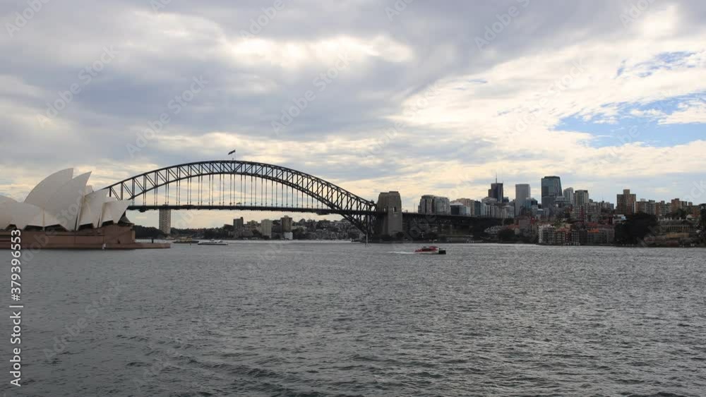 Time-lapse of ferries and boats in Sydney Harbour with clouds in the sky passing by vigorously Time-lapse of ferries and boats in Sydney Harbour with clouds in the sky passing by vigorously