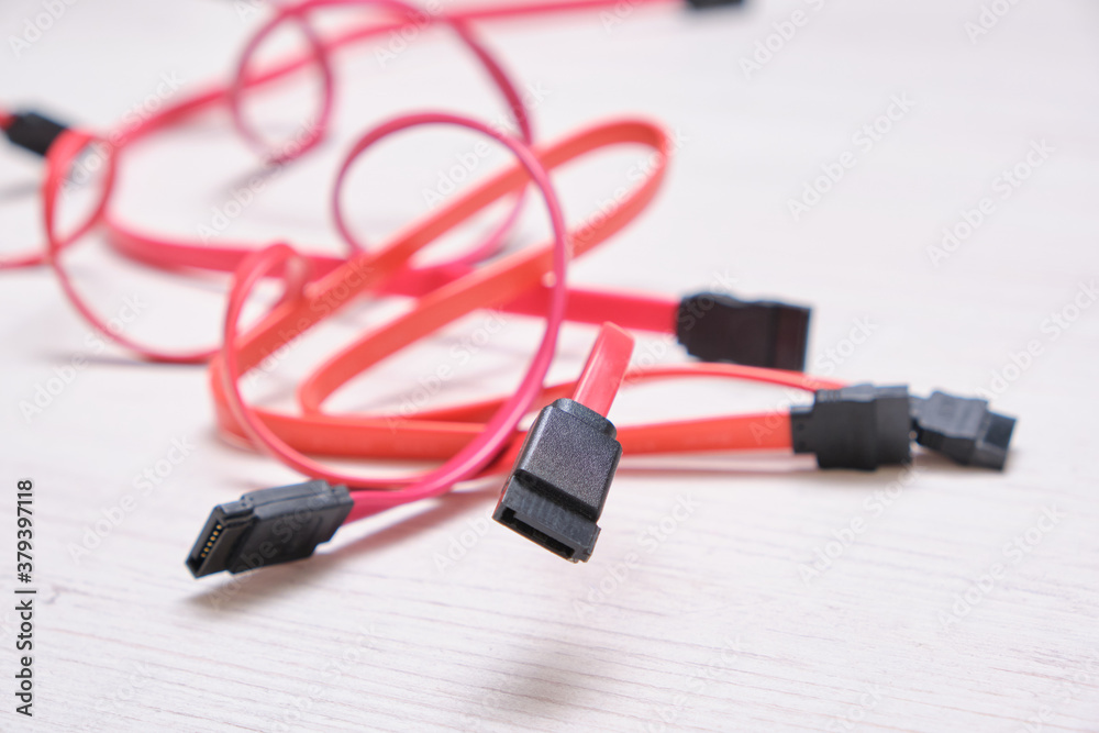 red computer wires for hard drive on light background red computer wires for hard drive on light background