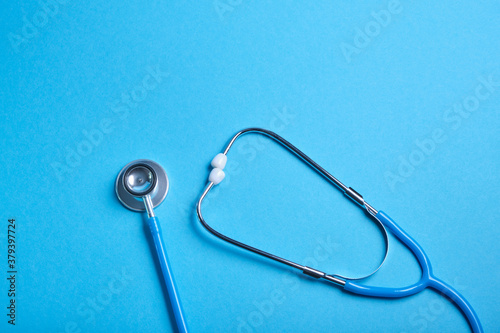 medical stethoscope on blue background, copy place, phonendoscope for diagnosing diseases