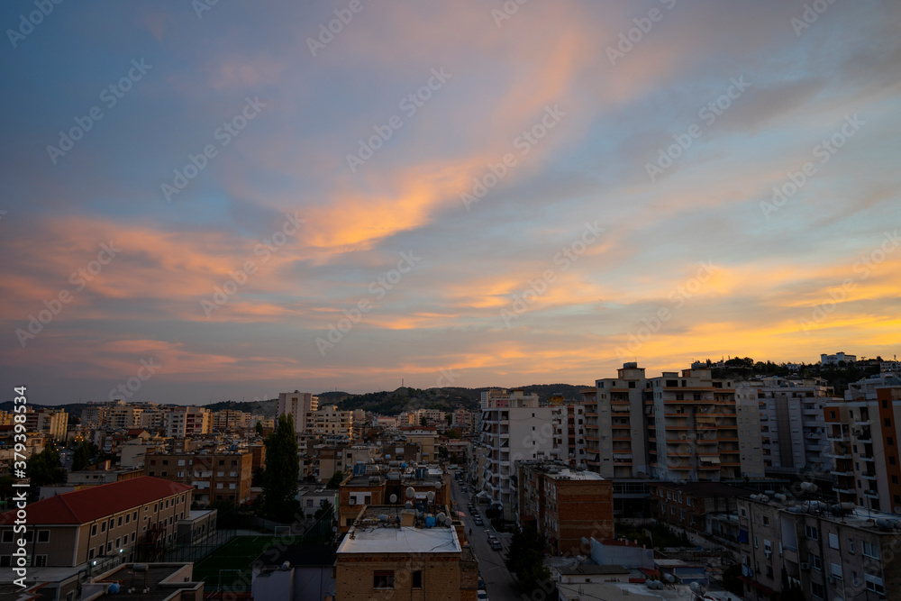 The beautiful cityscape of Albanian city Vlore, with cloudy blue sky.