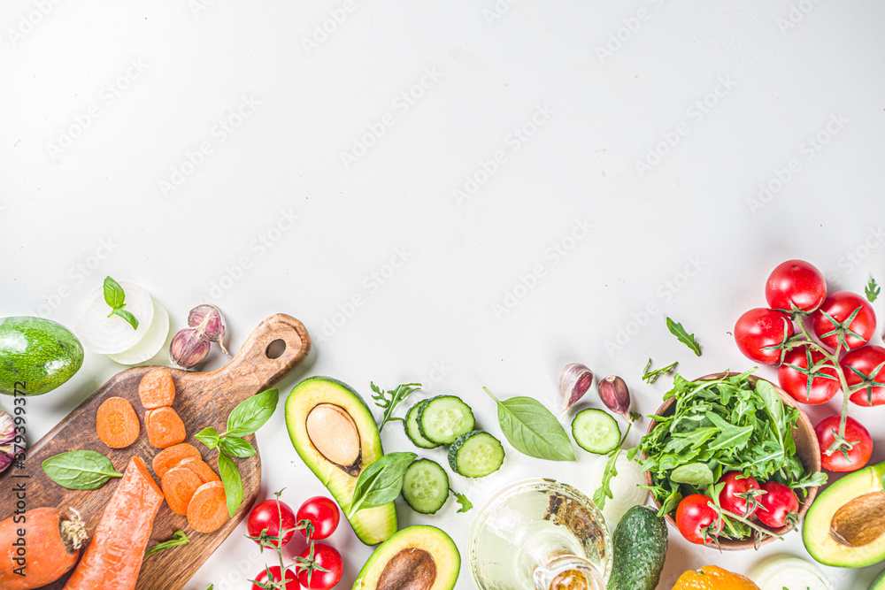 Organic fresh raw vegetables flatlay. Healthy food cooking background with various vegetable salad ingredients.  Vegetarian fresh raw food concept. Top view, copy space