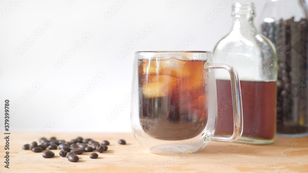Ice cold brew coffee on wooden table and white background. Ice cold brew coffee on wooden table and white background.