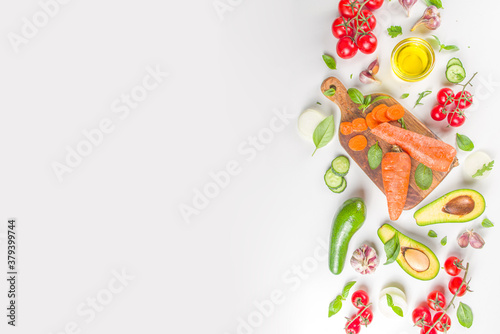 Organic fresh raw vegetables flatlay. Healthy food cooking background with various vegetable salad ingredients.  Vegetarian fresh raw food concept. Top view, copy space © ricka_kinamoto