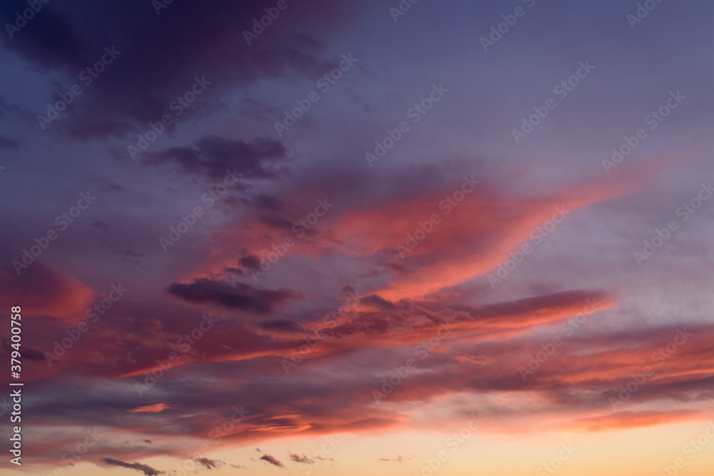 Dramatic sunset sky with orange colored clouds.