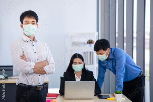 People wearing surgical mask while their work in office in covid-19 situation