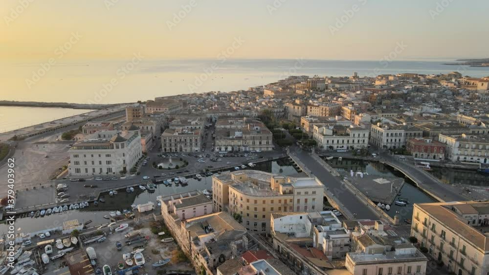 Drone above the sicilian island Ortygia (Ortigia), from the bridge Umberto and harbor above the island in province of Siracusa (Syracuse) in Sicily. Drone view
