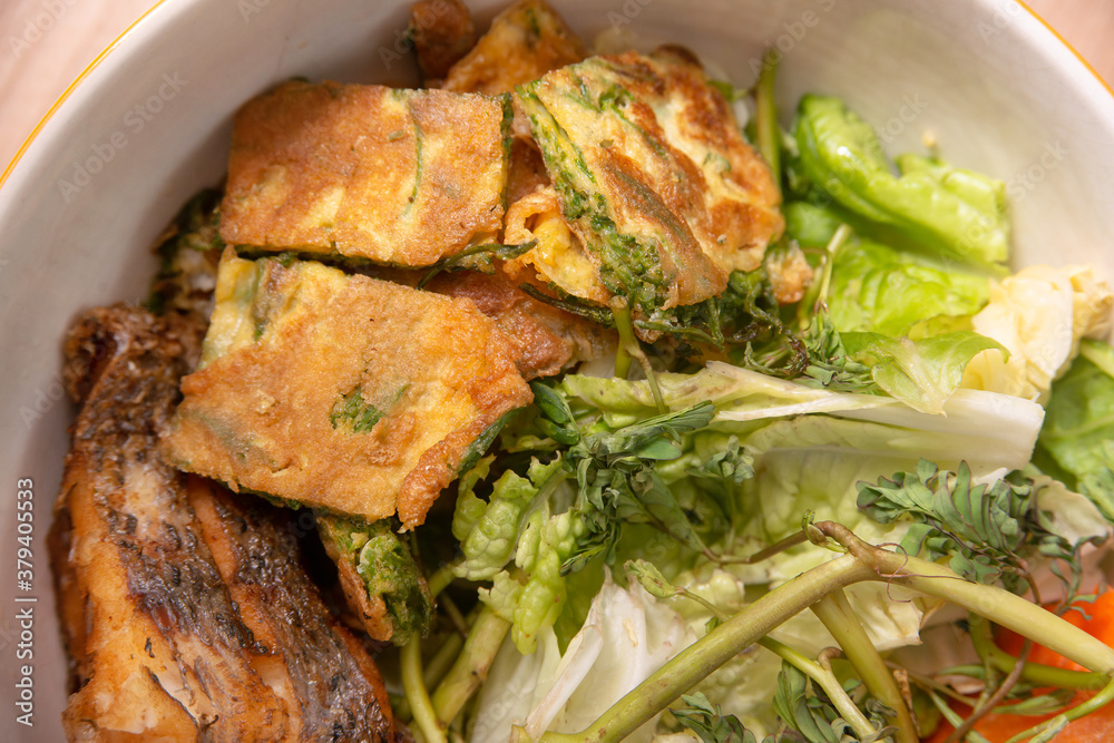 The ingredient of Thai red curry sour soup with deep fried fish fillet and fried egg