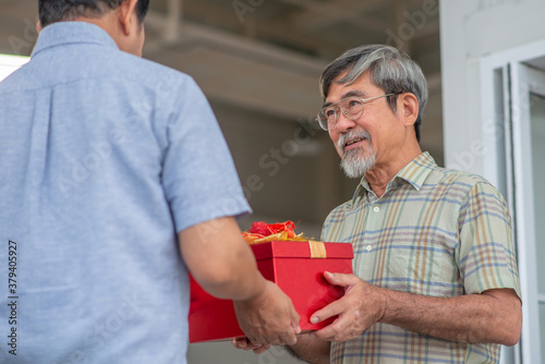 Retired fried recieving present with happiness
