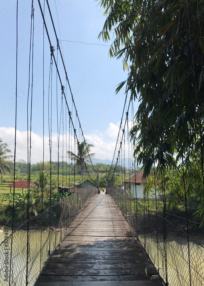 Obraz premium As a connection between the land separated by the river, this suspension bridge presents a very beautiful view of the countryside