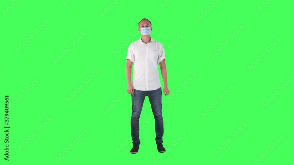 Smart casual business man put on wear and then remove surgical face mask. Full body on green screen. Smart casual business man put on wear and then remove surgical face mask. Full body on green screen.