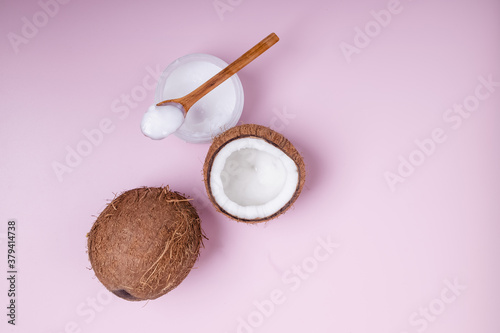 Healthy coconut oil on pink background