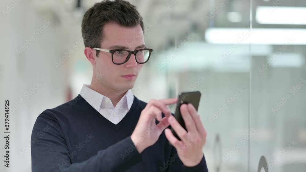 Young Businessman using Smartphone, Text Messaging Young Businessman using Smartphone, Text Messaging