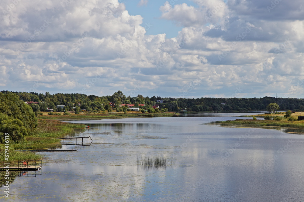 Hotcha river in Tver region near Volga, beautiful natural Russian landscape at Sunny summer day on blue sky with white clouds