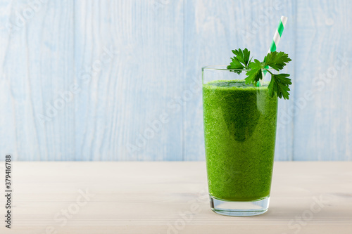 Fresh green smoothie on wooden table