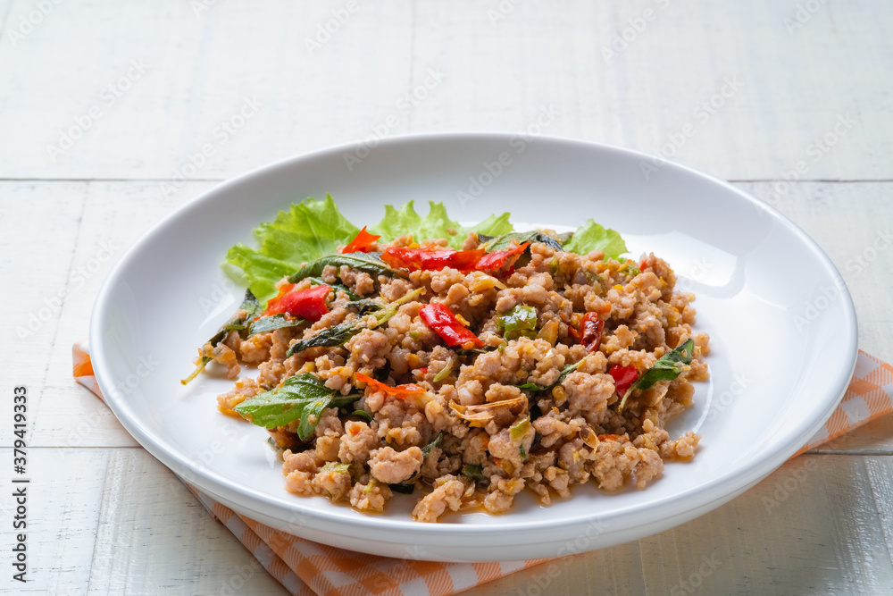 Stir fried Thai basil with minced pork on white plate