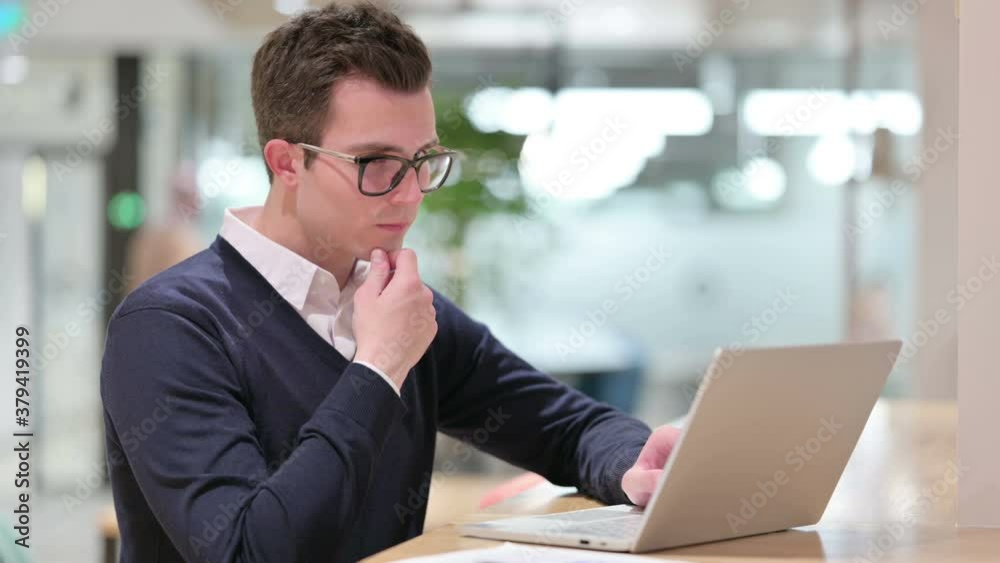 Pensive Young Businessman Thinking and Working on Laptop Pensive Young Businessman Thinking and Working on Laptop