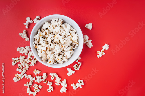 Bowl of popcorn on red background