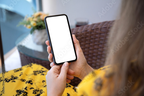 female hands in yellow dress hold phone with isolated screen