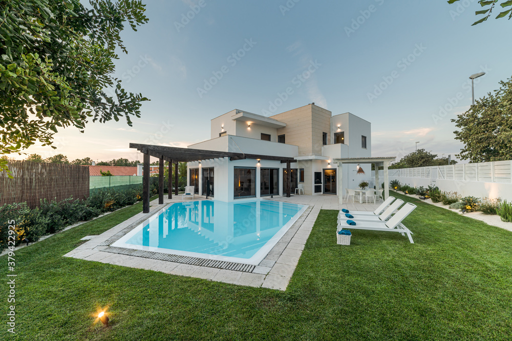 Modern house with garden swimming pool and wooden pergula