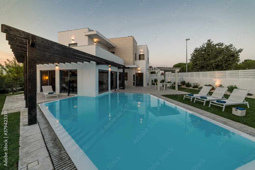 Fototapeta premium Modern house with garden swimming pool and wooden pergula