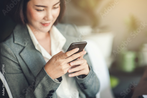 Smartphone on hand of business woman.