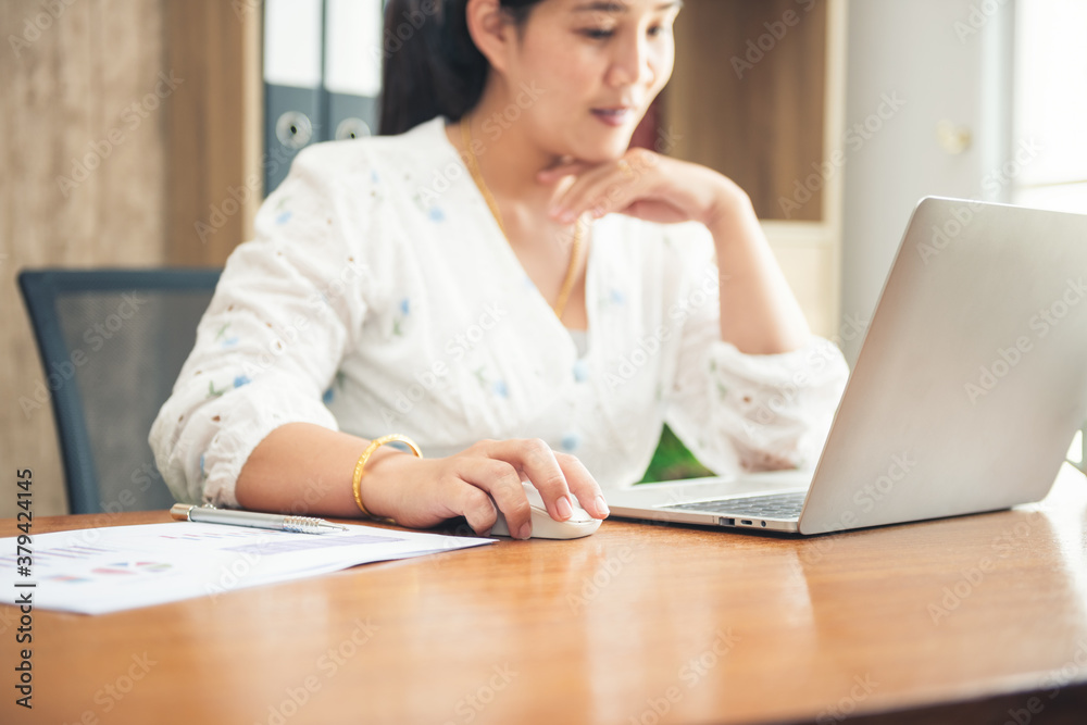 Asian business woman sitting working with laptop, computer on table at office or home or internet cafe. Work for safe at home. internet of things network concept. business continuity plan Asian business woman sitting working with laptop, computer on table at office or home or internet cafe. Work for safe at home. internet of things network concept. business continuity plan