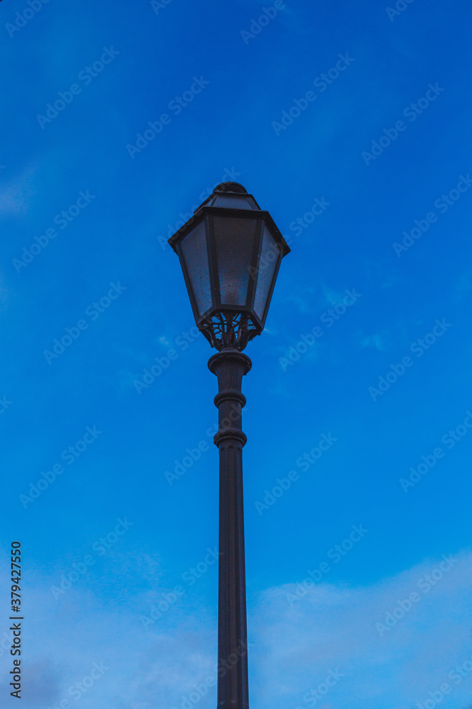 an old street lamp on sky background