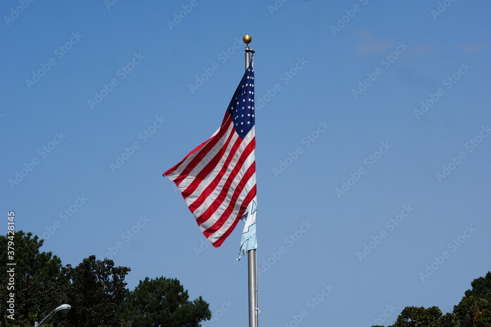 American Flag in the Wind with UNC flag 