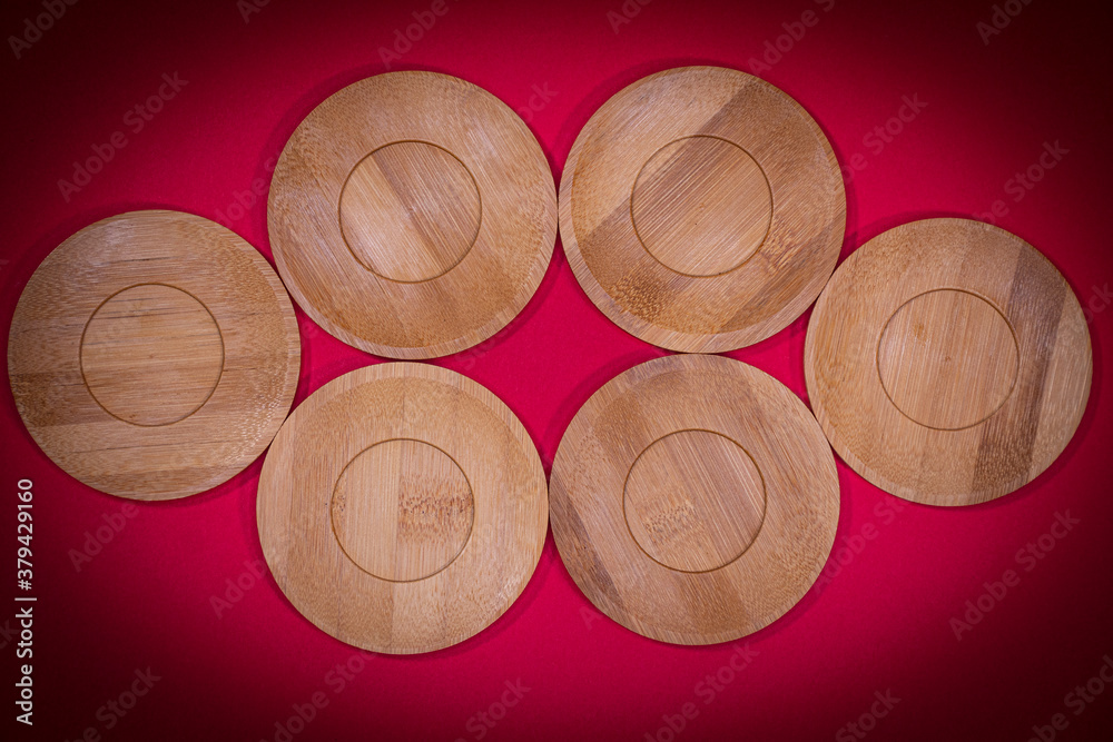 Bamboo saucers arranged in various order, with space to insert letters of text
