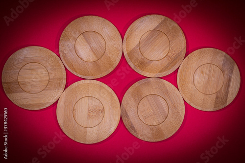 Bamboo saucers arranged in various order, with space to insert letters of text