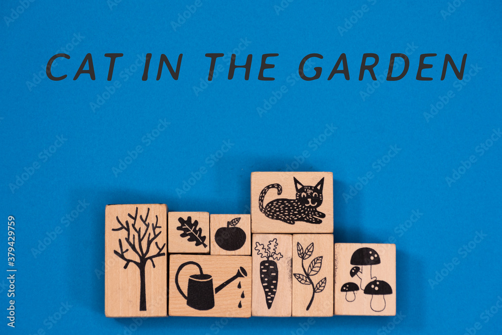 Wooden rectangles and cubes with figures relating to gardening and the garden