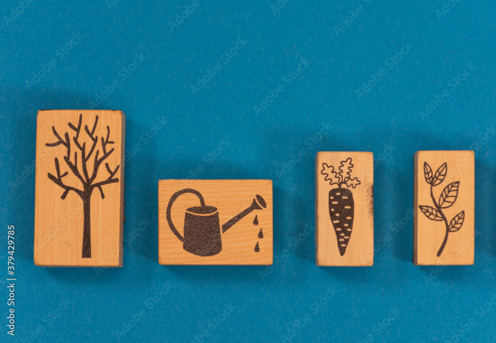 Wooden rectangles and cubes with figures relating to gardening and the garden