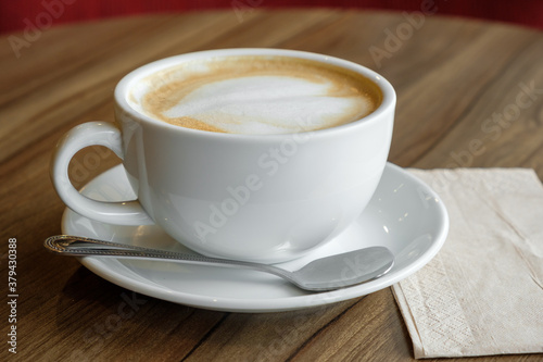 closed-up of hot drink coffee in white mug on brown wood table