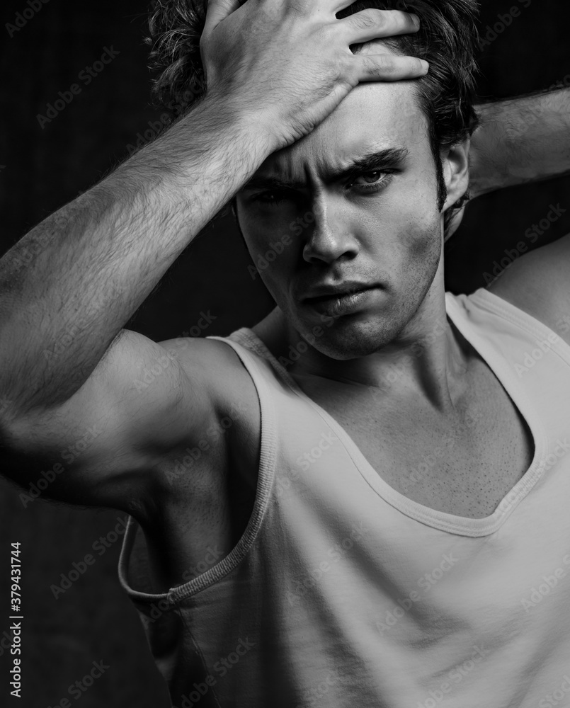 Sexy male model posing in white underwear in dark shadow background with  angry emotional look. Closeup portrait of strong handsome man. Black and  white foto de Stock | Adobe Stock