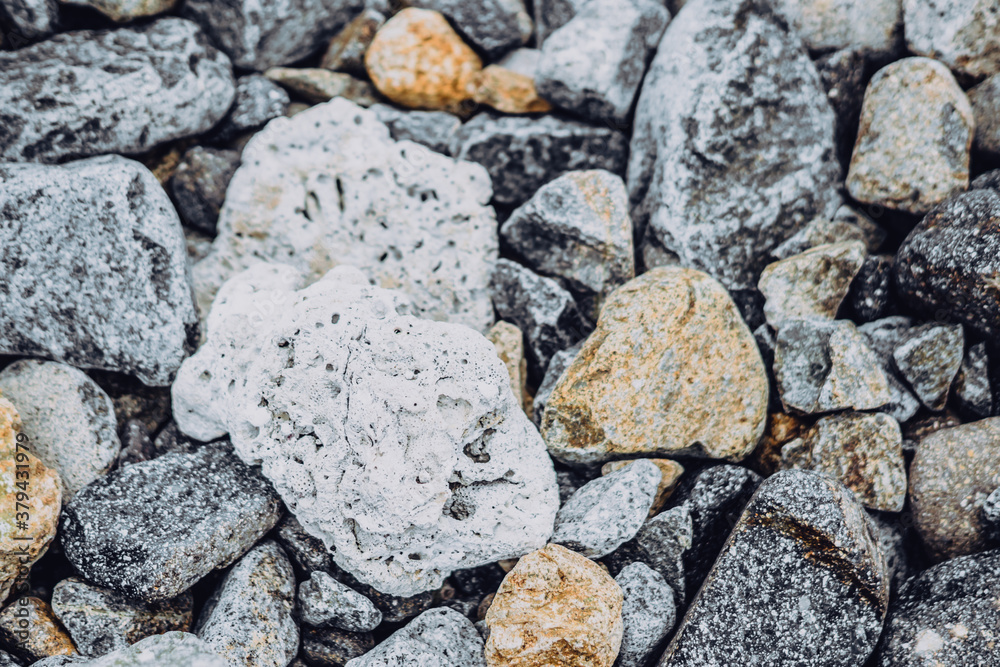 Small and big smooth round pebbles, sea dry stones, multicolour gray gravel. Abstract Composition Textured background. Ideal for web banner design Small and big smooth round pebbles, sea dry stones, multicolour gray gravel. Abstract Composition Textured background. Ideal for web banner design